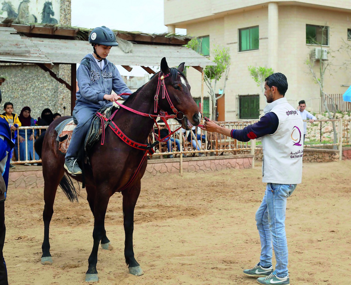 A boy learns horse riding in Gaza.