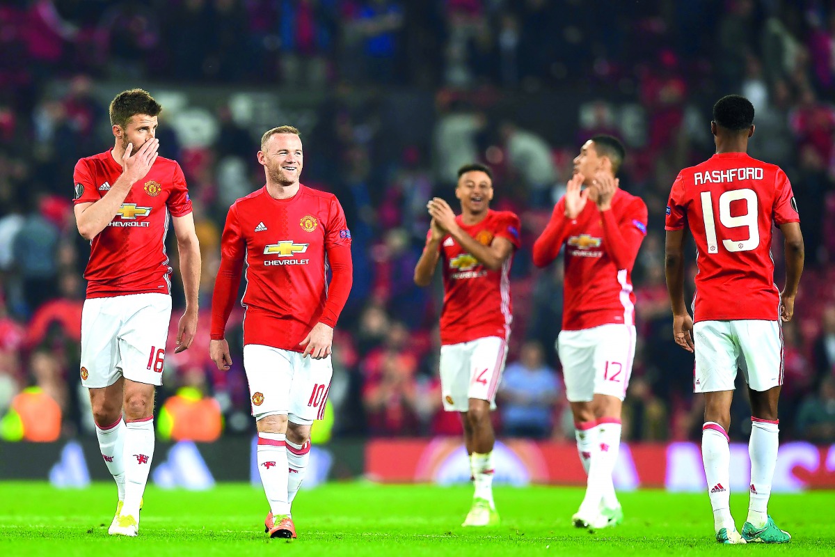 From left: Manchester United midfielder Michael Carrick, striker Wayne Rooney, midfielder Jesse Lingard, defender Chris Smalling and striker Marcus Rashford celebrate their win on the pitch after the UEFA Europa League semi-final, second-leg football matc