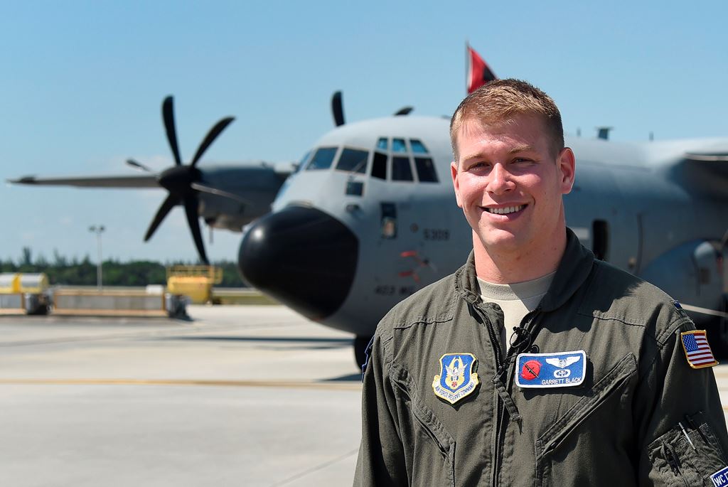 US Airforce meteorologist Garrett Black poses for a photo in front of US Air Force Hurricane Hunter WC-130 reconnaissance aircraft at the Coast Guard Air Station at Opa Locka Airport on May 12, 2017 in Miami, Florida. The aircraft is part of NOAA's Hurric