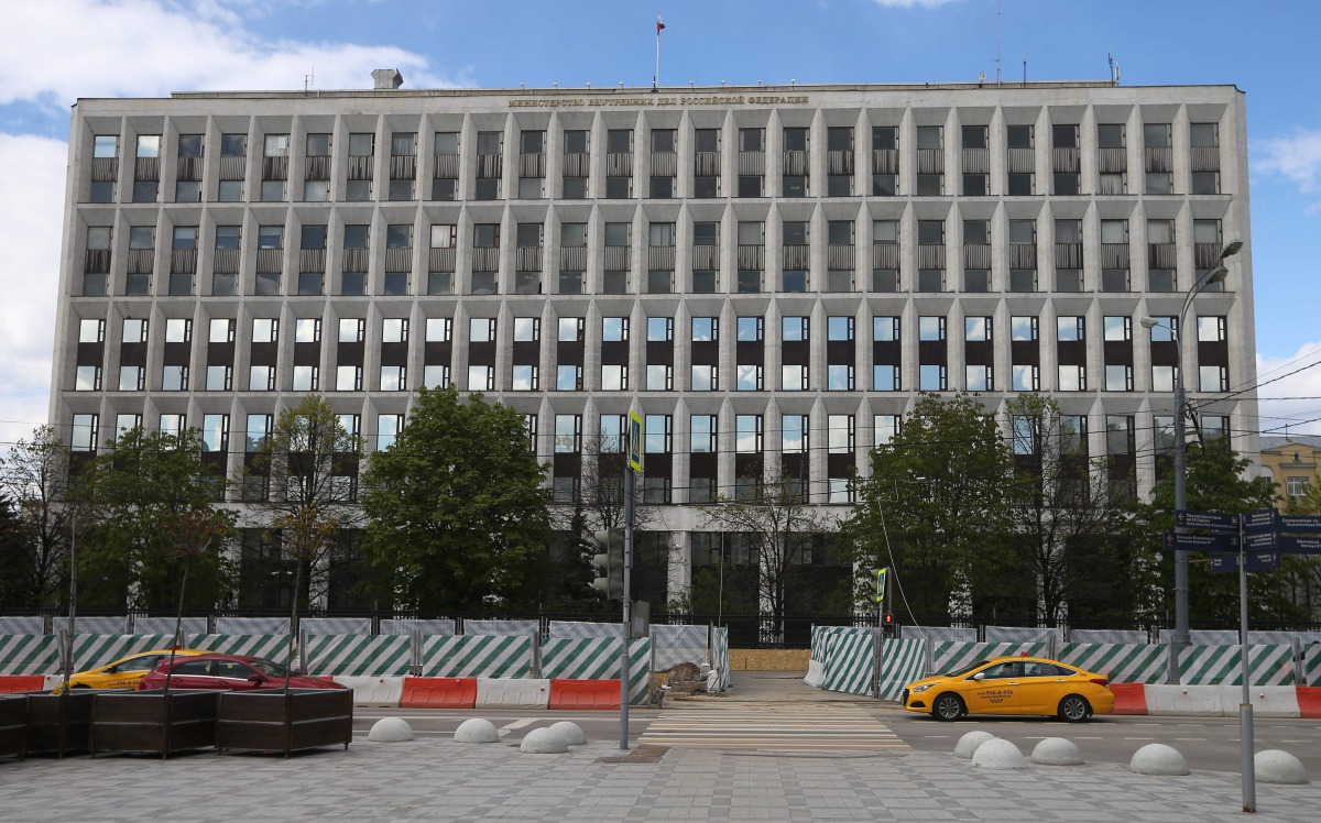 People drive vehicles in front of the Russian Interior Ministry building on May 13, 2017 in Moscow. Russia's interior ministry said on May 12, 2017 that some of its computers had been hit by a 