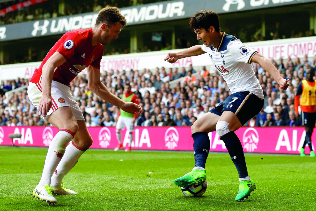 Tottenham Hotspur's striker Son (right) vies with Manchester United midfielder Michael Carrick during the English Premier League match at White Hart Lane in London