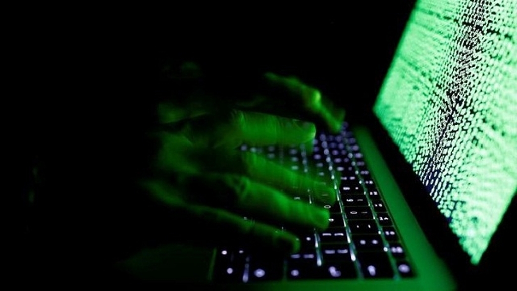 A man types on a computer keyboard in front of the displayed cyber code in this illustration picture taken on March 1, 2017. (Reuters).