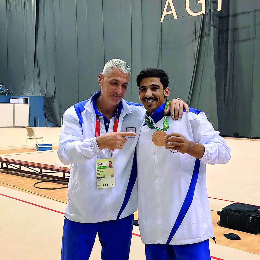 Qatari gymnast Ahmed Al Dayani (right) shows off his bronze medal won at the Islamic Solidarity Games in Baku.