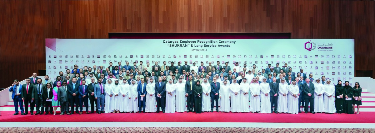 Qatargas CEO Khalid bin Khalifa Al Thani, and senior management officials pose for a group photo with employees.