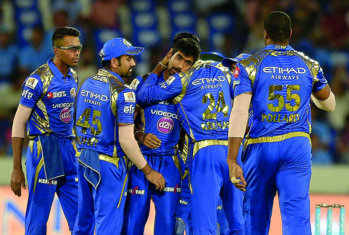 Jasprit Bumrah (centre) of Mumbai Indians celebrates with team-mates after the dismissal of unseen Rising Pune Supergiant batsman Rahul Tripathi during the IPL Twenty20 final match against Rising Pune Supergiant at The Rajiv Gandhi International Cricket S