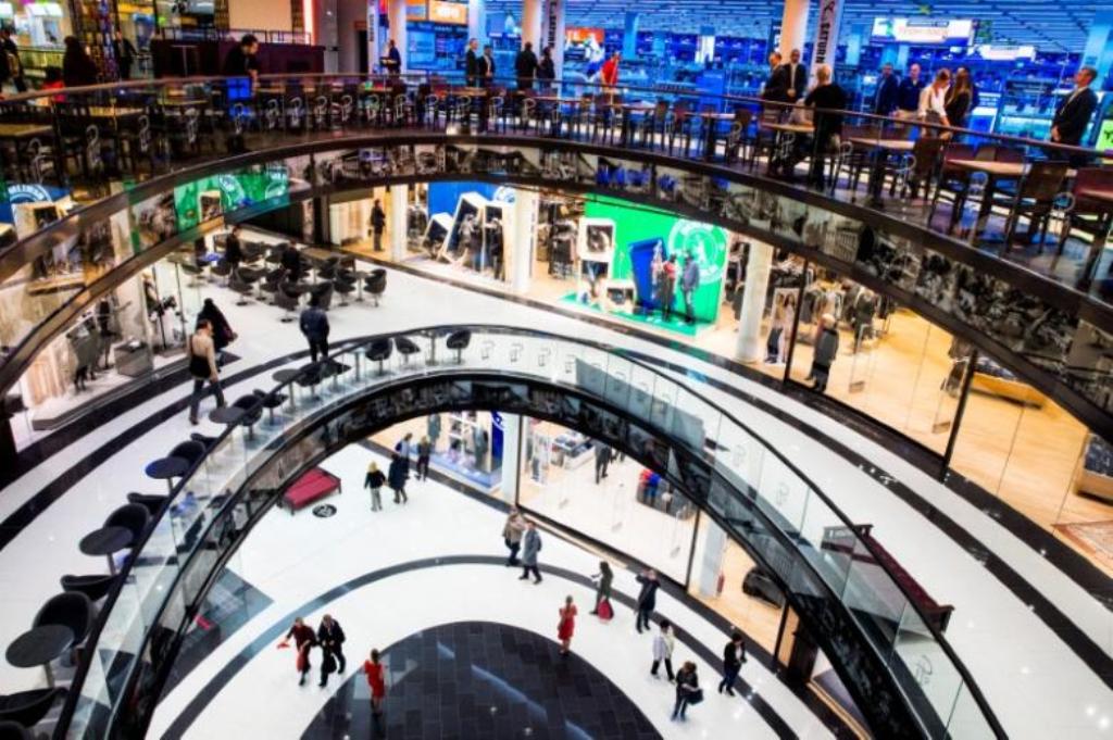 People walk through the Mall of Berlin shopping centre in Berlin, September 24, 2014