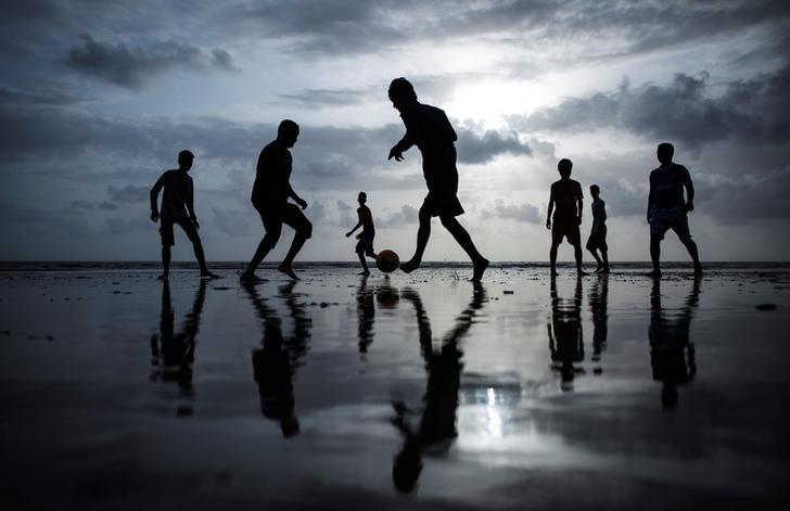 File picture of people playing football at a beach in Mumbai, June 25, 2014. REUTERS/Danish Siddiqui/Files