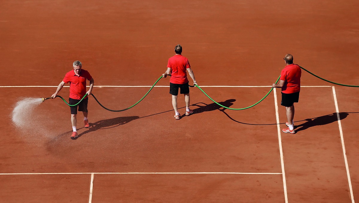 Supporting staff water the court at Roland Garros, Paris, France during a French Open final in this file photo.
