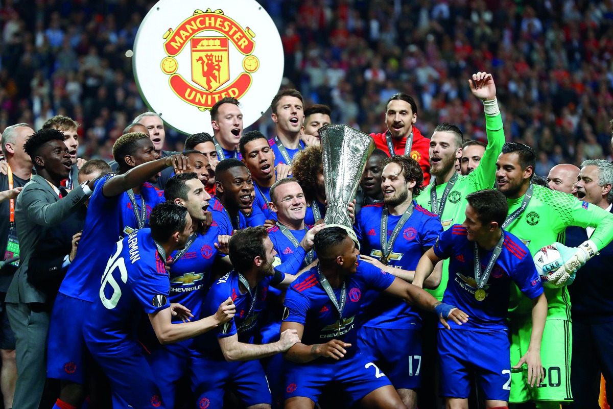 Manchester United's players and officials celebrate with the UEFA Europa League trophy after defeating Ajax Amsterdam in the final at the Friends Arena in Solna, Sweden on Wednesday.