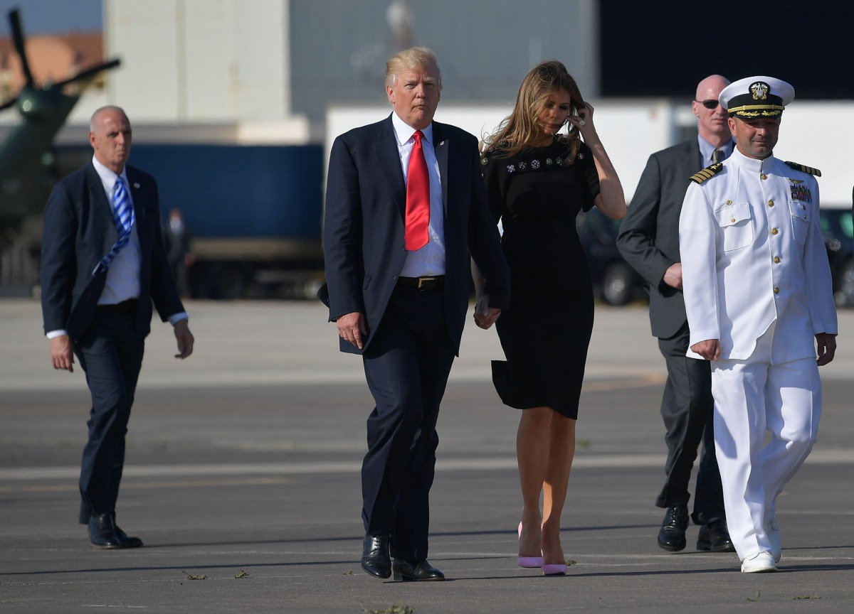 US President Donald Trump and US First Lady Melania Trump walk to board Air Force One before departing from US military Naval Air Station Sigonella following a G7 summit of Heads of State and Government, on May 27, 2017 near Taormina in Sicily. (AFP / MAN