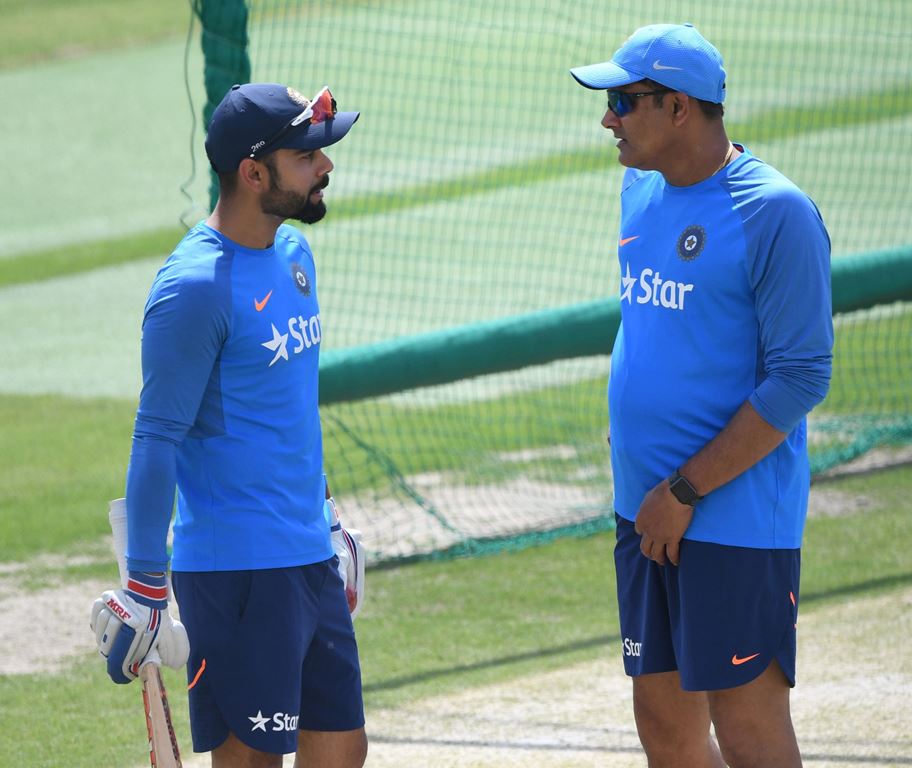 (FILES) This file photo taken on March 24, 2017 shows India's cricket coach Anil Kumble (R) talking with captain Virat Kohli during a training session on the eve of a Test match between India and Australia at the Himachal Pradesh Cricket Association Stadi