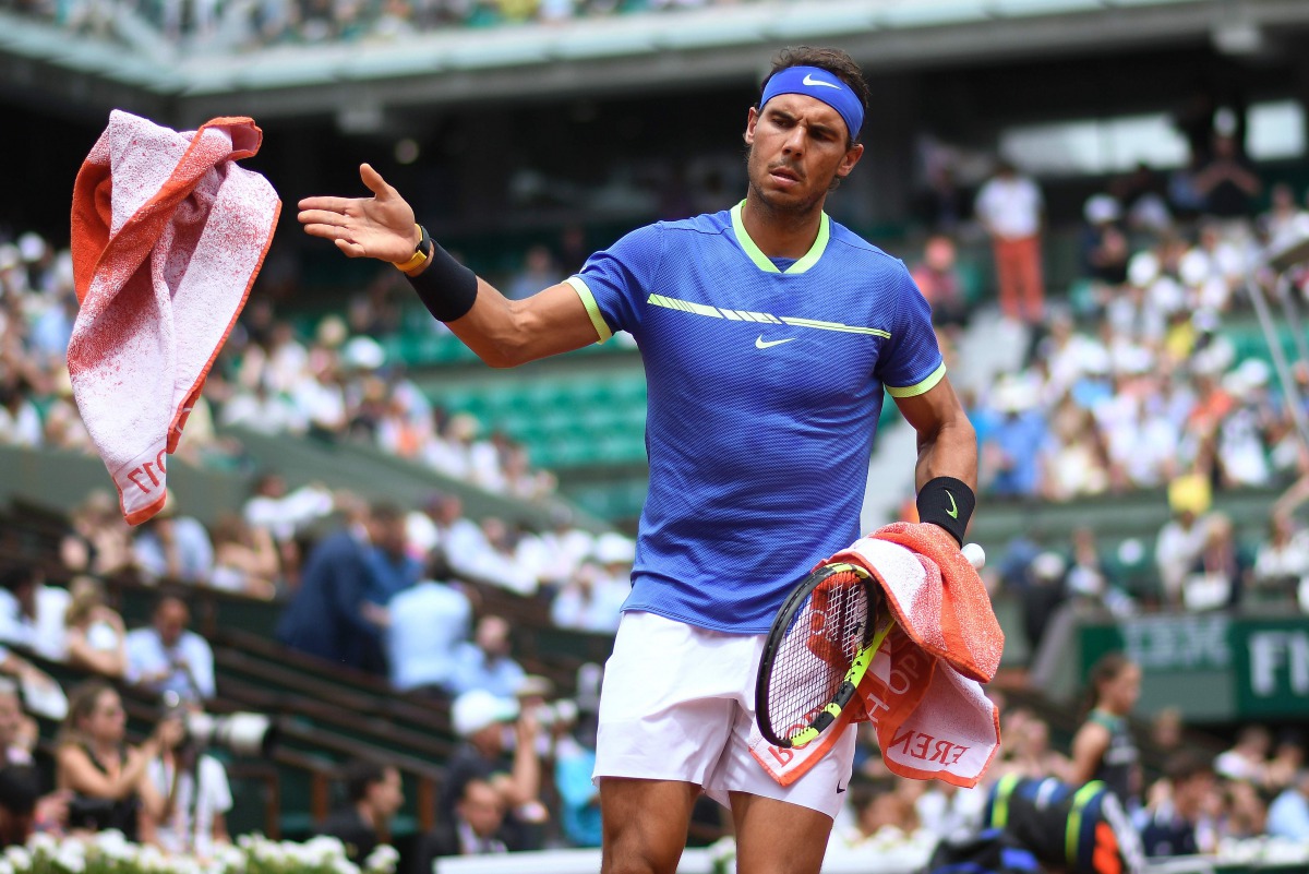 Spain's Rafael Nadal gives a towel back as he plays against Georgia's Nikoloz Basilashvili during their tennis match at the Roland Garros 2017 French Open on June 2, 2017 in Paris. (AFP / Lionel Bonaventure)