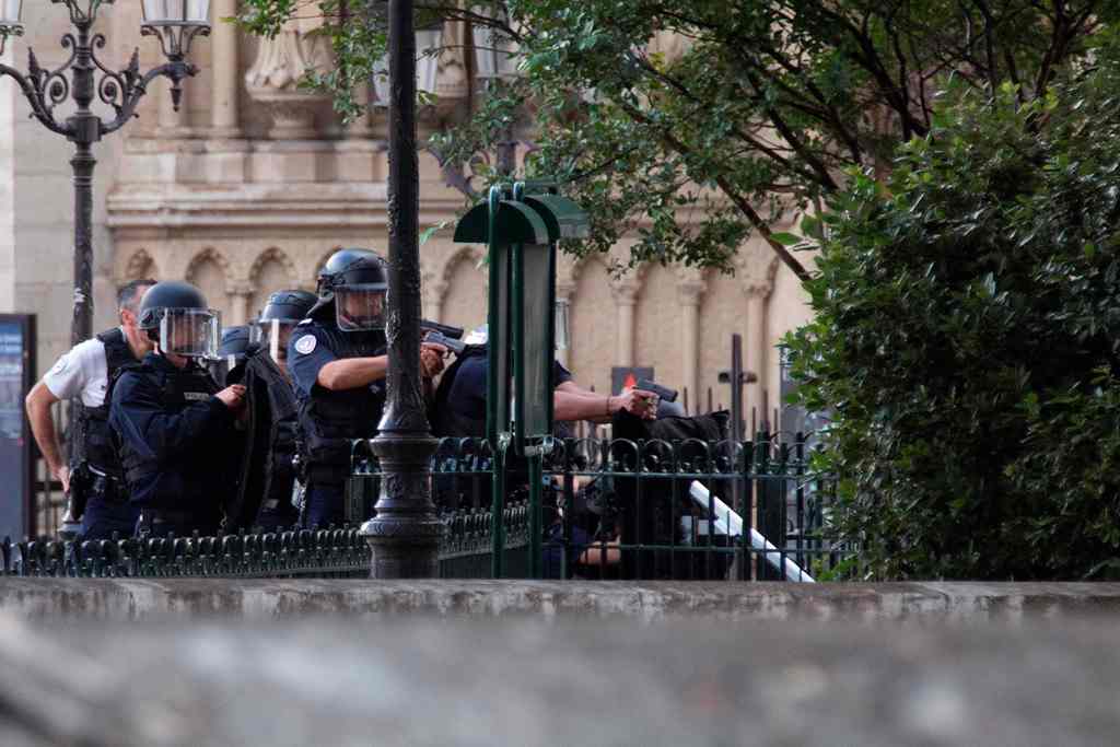 French policemen point their weapons near the site of an attack at the entrance of Notre-Dame cathedral in Paris on June 6, 2017. AFP / Karim DAHER