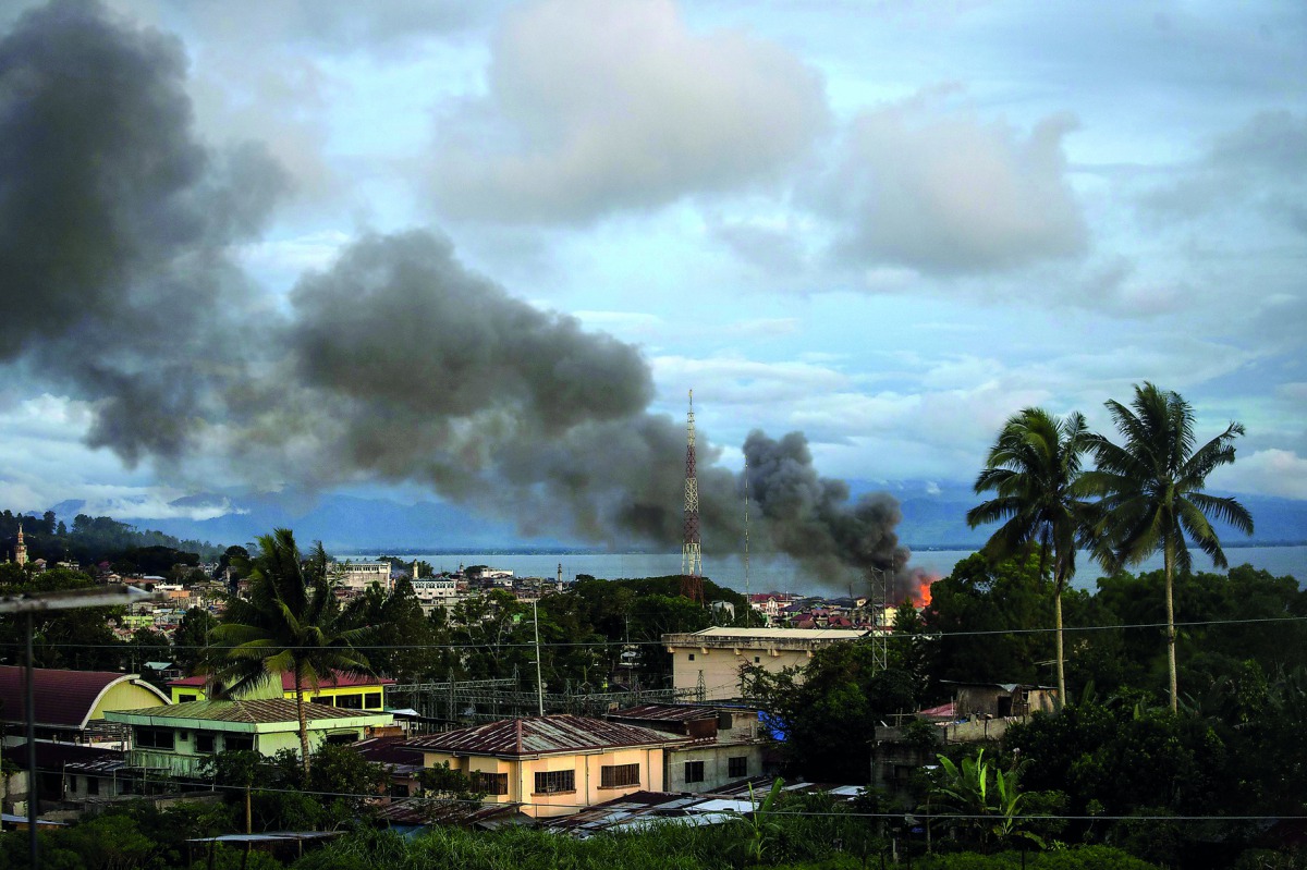 Smoke rises after aerial bombings by Philippine Air Force planes on militant positions in Marawi, on the southern Philippine island of Mindanao, yesterday.
