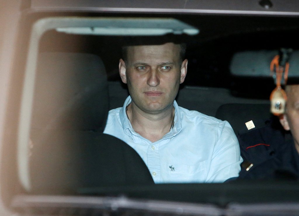 Russian opposition leader Alexei Navalny sits in a police car after being found guilty by a court of repeatedly violating the law on organizing public meetings, in Moscow, Russia, June 13, 2017. REUTERS/Sergei Karpukhin
