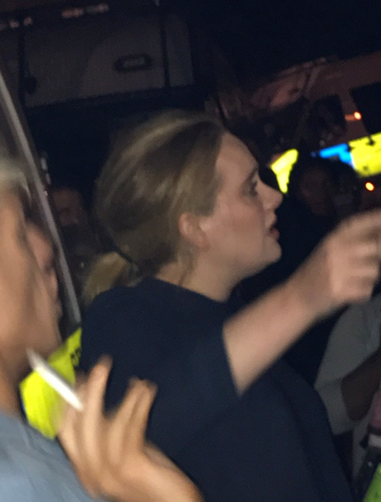 Singer Adele is pictured near the Grenfell Tower apartment block at Latimer Road in West London, Britain June 15, 2017, in this picture obtained from social media. TWITTER: FOURMEE via REUTERS 