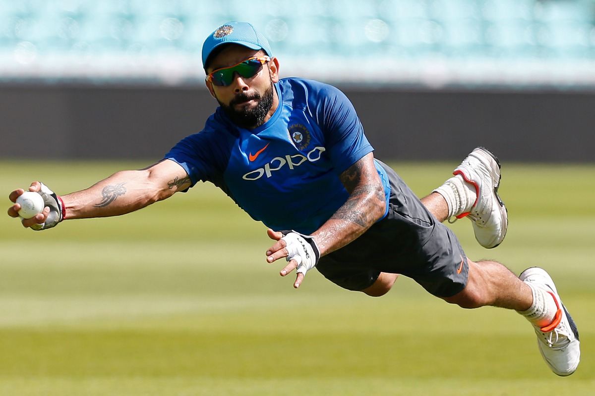 India's captain Virat Kohli dives to make a catch as he attends a nets practice session at The Oval in London on June 17, 2017, on the eve of the ICC Champions Trophy Final cricket match between India and Pakistan. (AFP / Ian KINGTON)