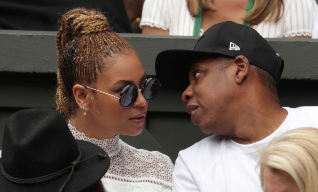 (FILES) This file photo taken on July 9, 2016 shows US singer Beyonce (L) and her husband US rapper Jay Z (R) sitting in the players box to watch Serena Williams play against Germany's Angelique Kerber during the women's singles final of the 2016 Wimbledo