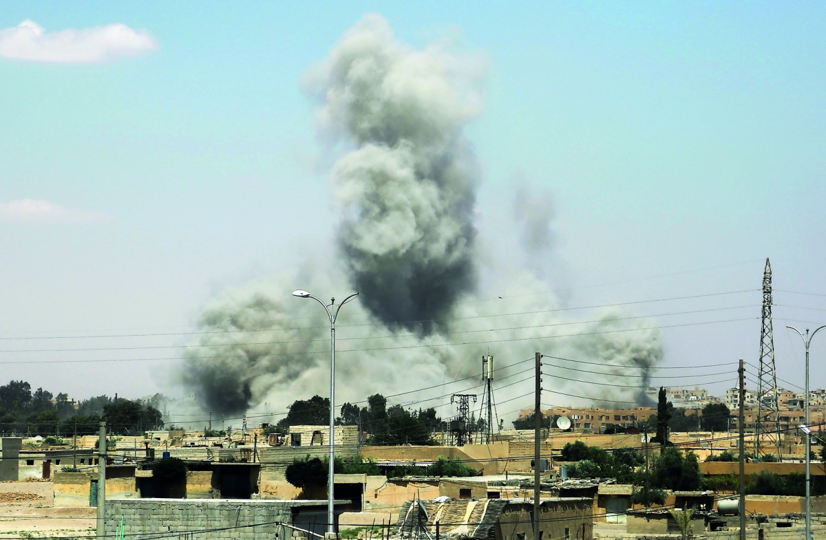 Smoke billows from buildings in the northern Syrian city of Raqqa, yesterday,  during an offensive by US-backed fighters to retake the Islamic State (IS) group bastion.  
