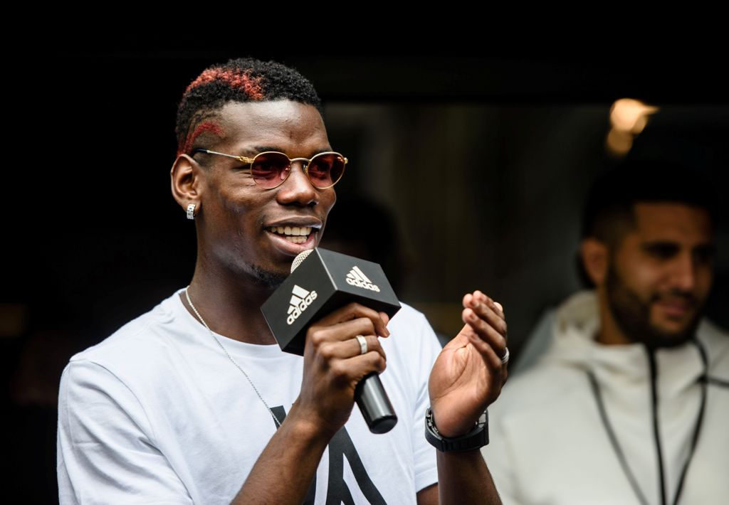 French central midfielder footballer Paul Pogba (L), 24, who plays for Premier League club Manchester United and France's national team, speaks at a promotional event in Hong Kong on June 19, 2017. / AFP / Anthony WALLACE
