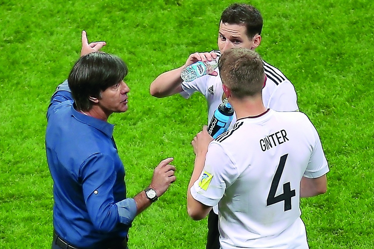 Germany's coach Joachim Loew (left) speaks to Germany's defender Matthias Ginter during the 2017 Confederations Cup group B match against Chile at the Kazan Arena Stadium in Kazan on Thursday.