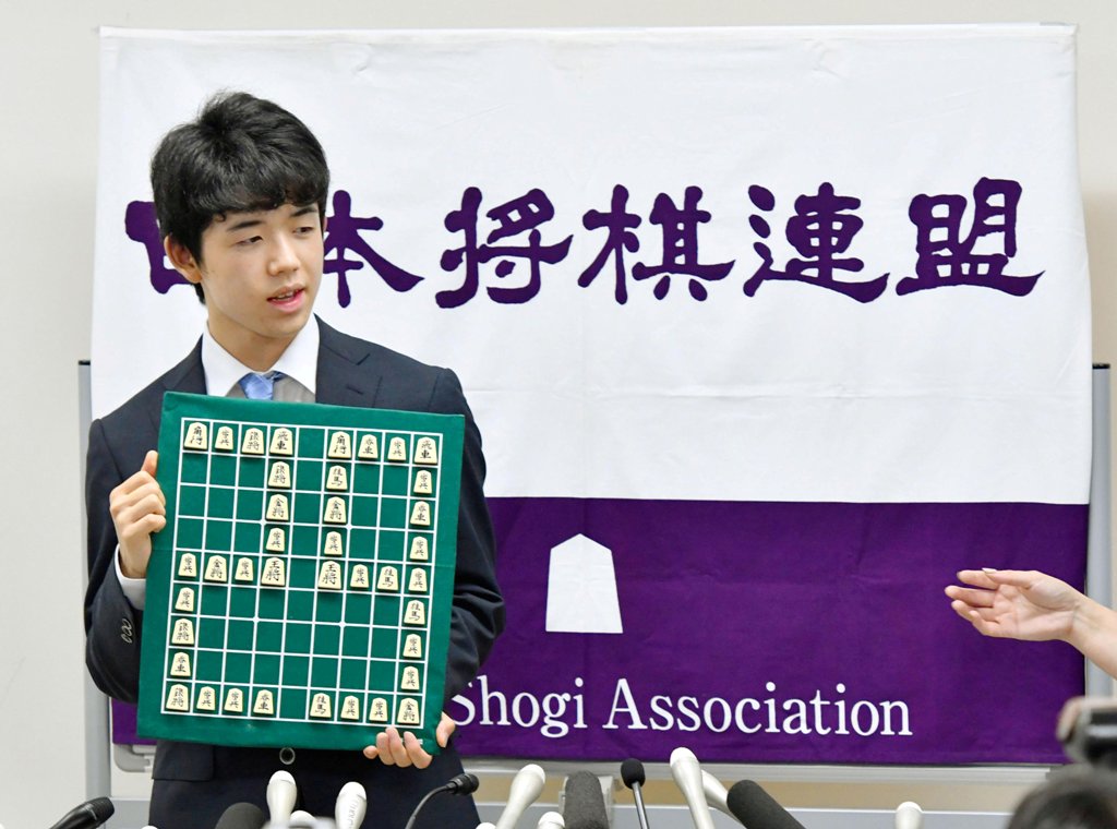 Japan's youngest professional shogi player, 14-year-old Sota Fujii, holds a shogi board with the number 29 portrayed with shogi pieces at the Shogi Kaikan hall in Tokyo, Japan June 26, 2017. Kyodo/via REUTERS