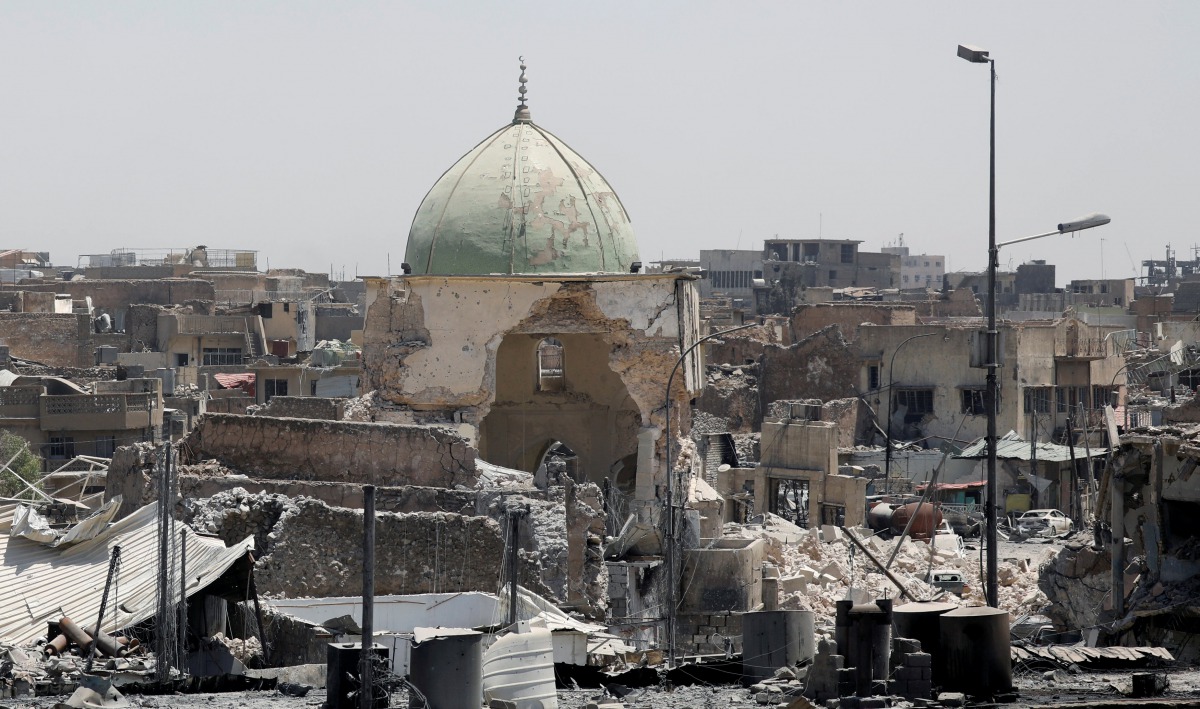 A destroyed mosque is seen among other houses near the Grand Al-Nuri mosque at the frontline in the Old City of West Mosul, Iraq June 27, 2017. REUTERS/Erik De Castro/File Photo