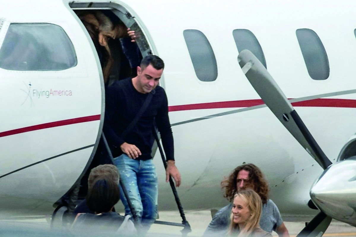 Barcelona legend and Al Sadd captain  Xavi Hernandez (centre) and Charles Pujol (right) arrive at Rosario's Airport, Santa Fe Province, Argentina yesterday to attend the wedding of Argentine football star and player of Spanish Barcelona, Lionel Messi.