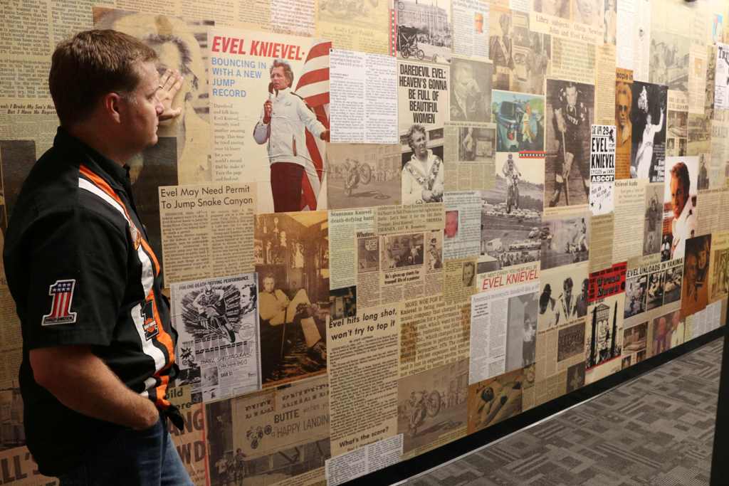 Mike Patterson, owner of historic Harley-Davidson and founder of The Evel Knievel Museum in Topeka, Kansas, surveys the wall of news clippings about the daredevil stunt rider in his Evel Knievel Museum on June 21, 2017. AFP / Beth Lipoff 