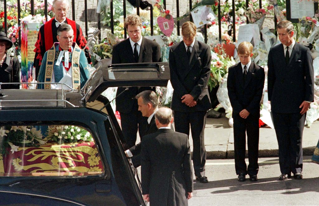 FILE PHOTO: Earl Spencer, Prince William, Prince Harry and Prince Charles watch as the coffin of Diana, Princess of Wales is placed into a hearse at Westminster Abbey following her funeral service, London, Britain September 6, 1997. REUTERS/Kieran Doherty