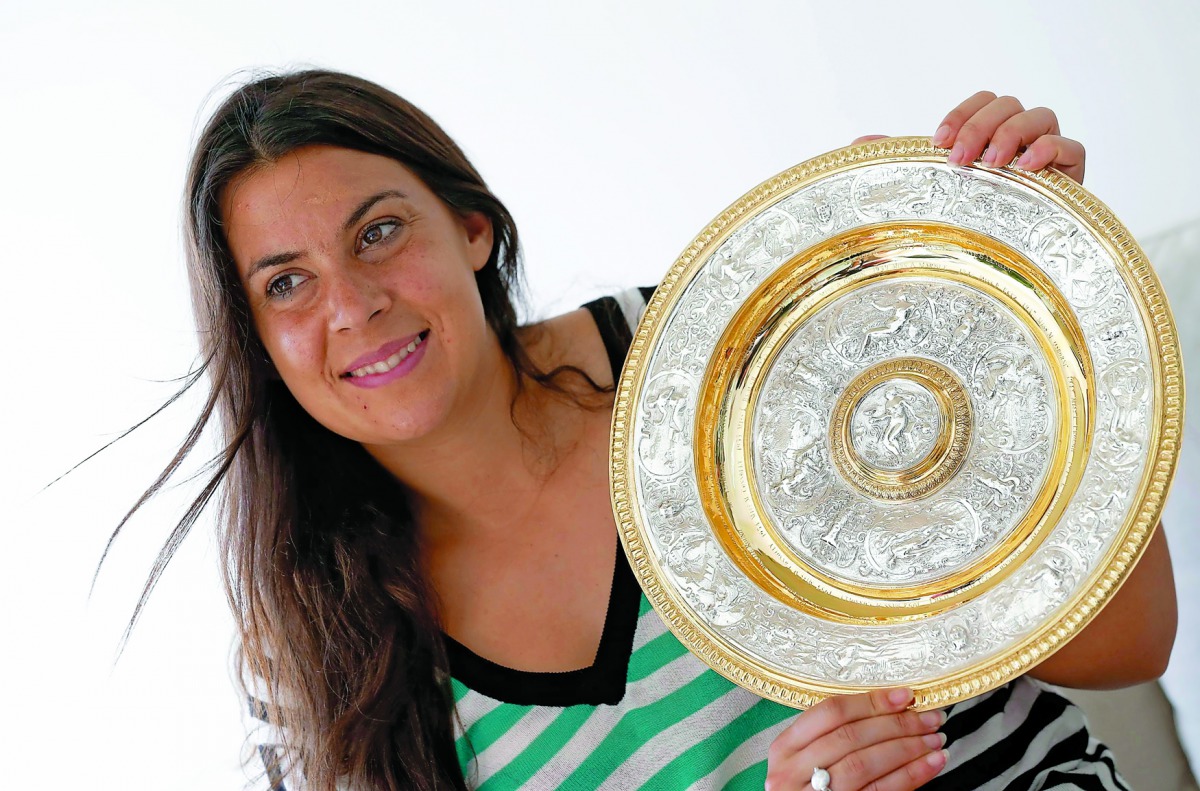 Wimbledon women’s singles champion Marion Bartoli of France holds her trophy in Boulogne-Billancourt near Paris, in this July 10, 2013 file picture.