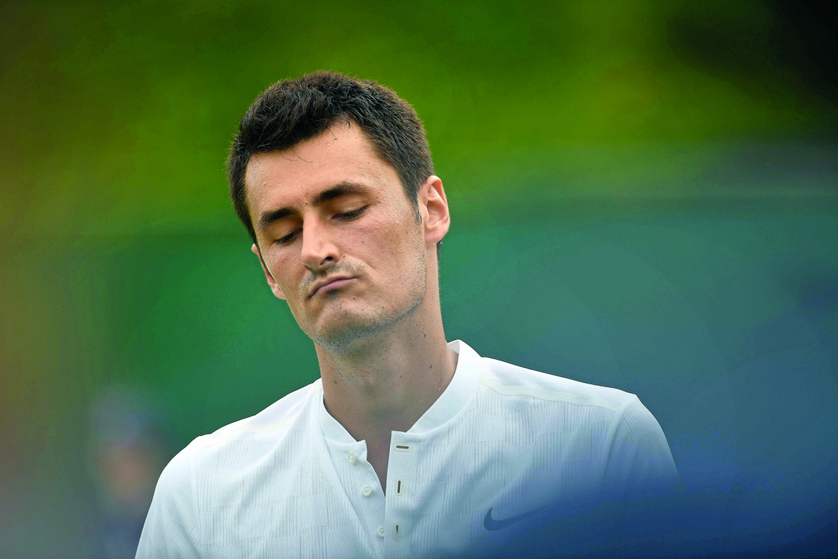 Australia's Bernard Tomic reacts against Germany's Mischa Zverev during their men's singles first round match at Wimbledon.