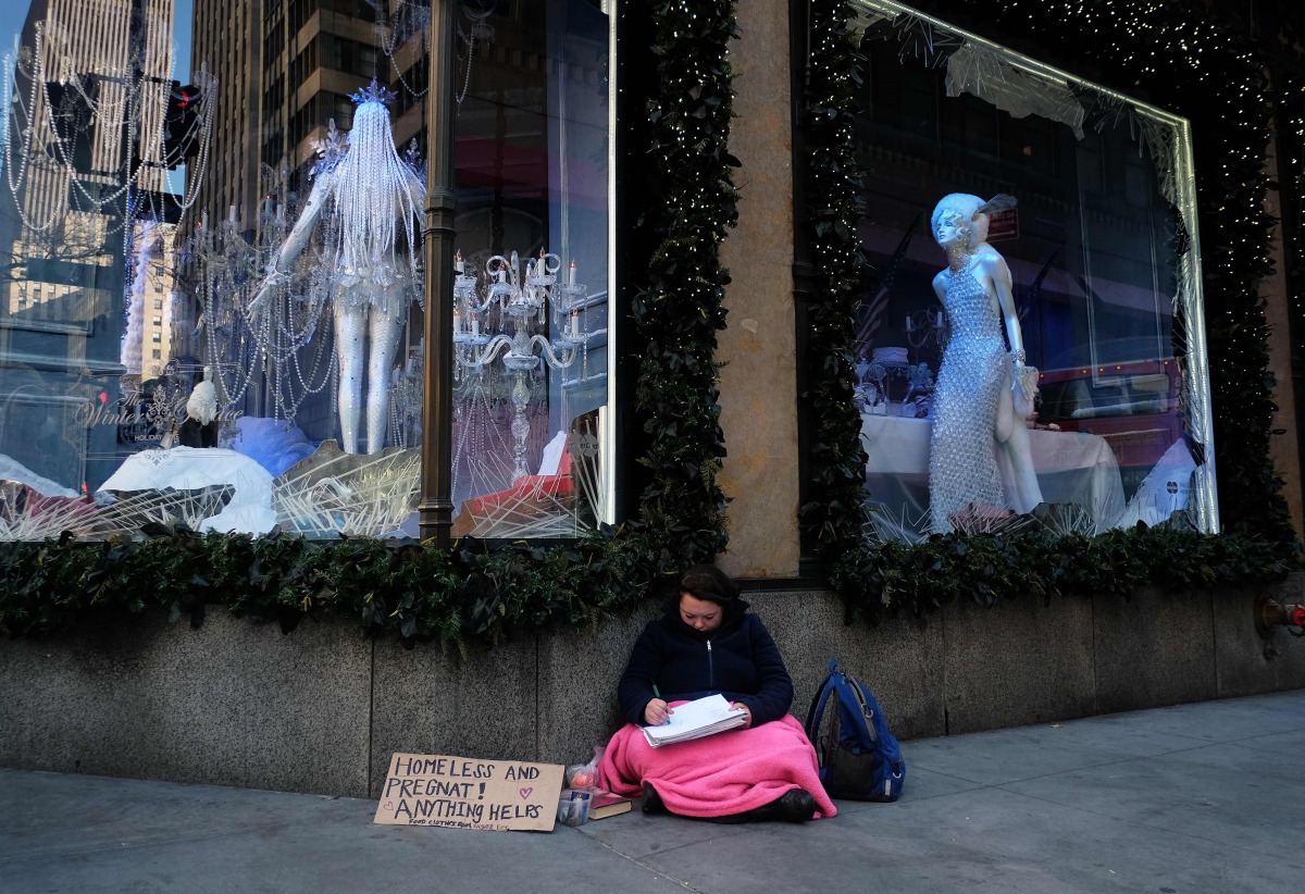 File photo taken on November 24, 2015 shows a homeless woman in front of a store on Fifth Avenue in New York (AFP / JEWEL SAMAD)