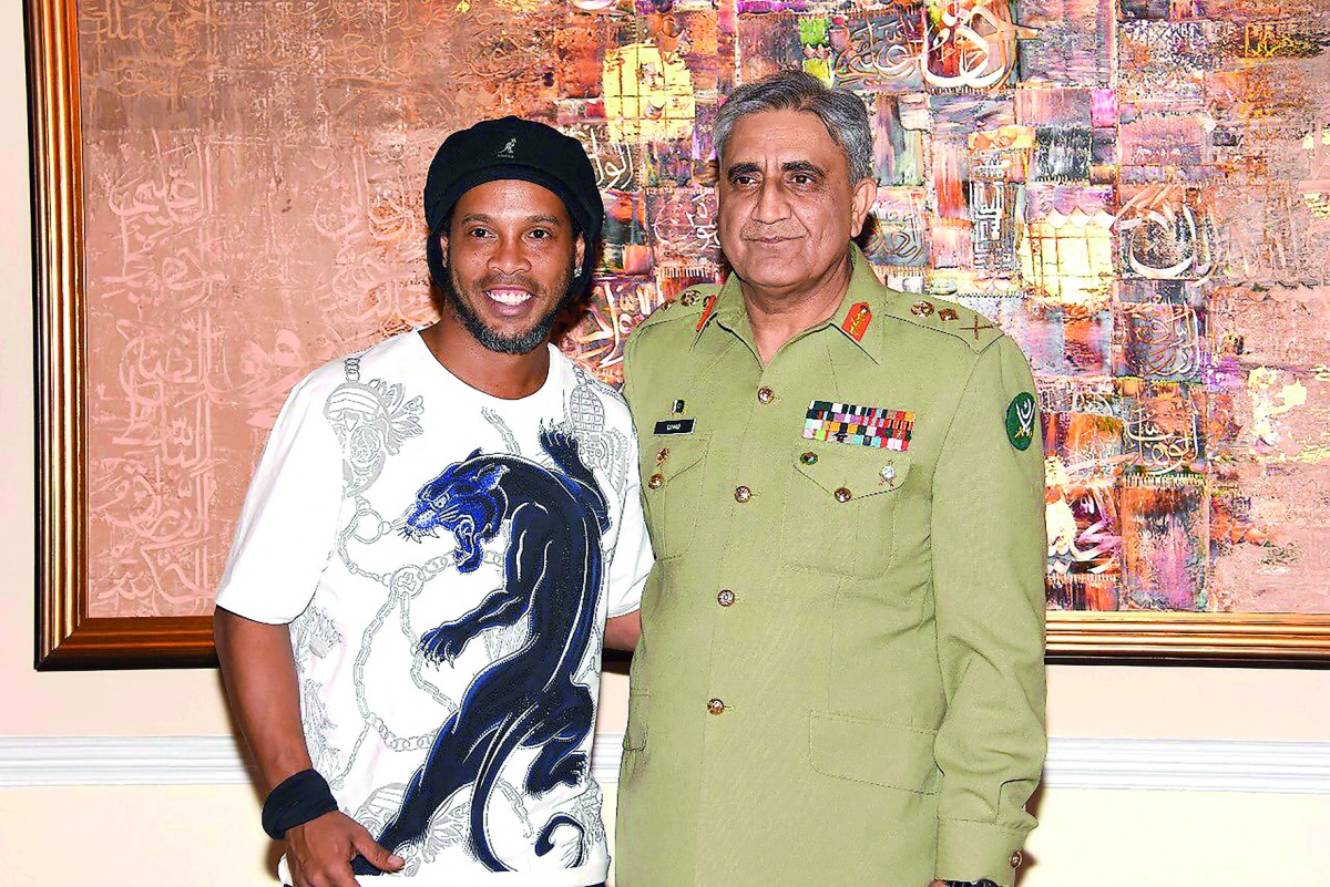 Brazilian football legend  Ronaldinho (left) poses for photograph with Pakistani Army Chief General Qamar Javed Bajwa during his visit to Pakistan to play in two exhibition games, in Rawalpindi. 