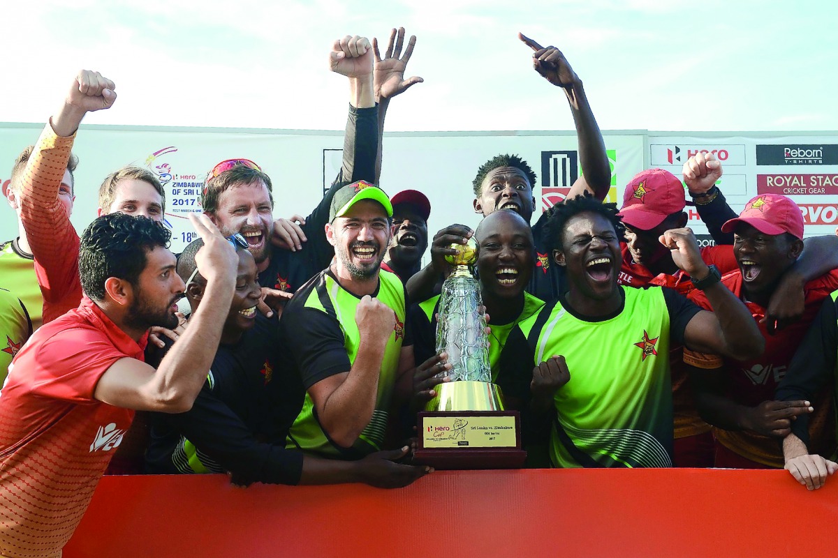 Zimbabwe cricketers pose for photographers after victory in the fifth one-day international (ODI) match against Sri Lanka at the Suriyawewa Mahinda Rajapakse International Cricket Stadium in the southern district of Hambantota, yesterday.