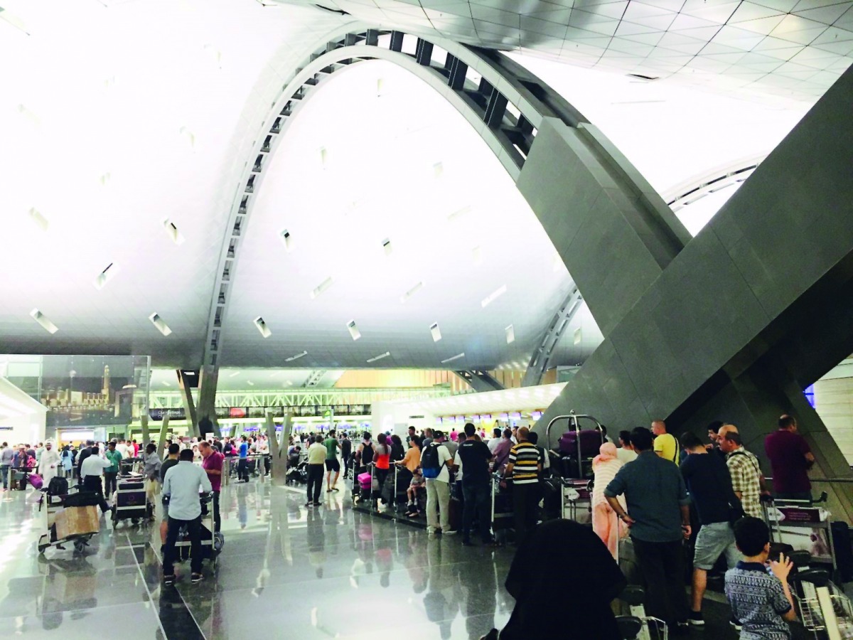 Passengers waiting for check-in at the departure lounge of Hamad International Airport.