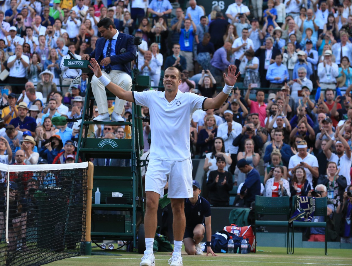 Gilles Muller of Luxembourg celebrates after beating Rafael Nadal of Spain on day seven of the 2017 Wimbledon Championships at the All England Lawn and Croquet Club in London, United Kingdom on July 10 2017. (Lindsey Parnaby - Anadolu Agency)