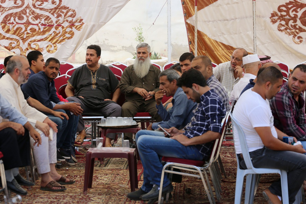 Relatives of 17-year-old Mohammed Jawawdeh, who was shot dead by an Israeli security guard, gather in a mourning tent in the capital Amman on July 24, 2017. AFP / Khalil Mazraawi