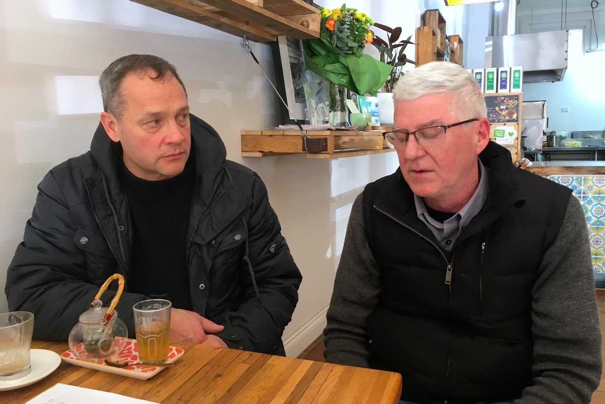 Peter Blenkiron and Philip Nagle react as they sit in a cafe in Cardinal George Pell's hometown, just days before the Vatican treasurer's first court appearance on historic sex charges, in the town of Ballarat, located west of the southern city of Melbour
