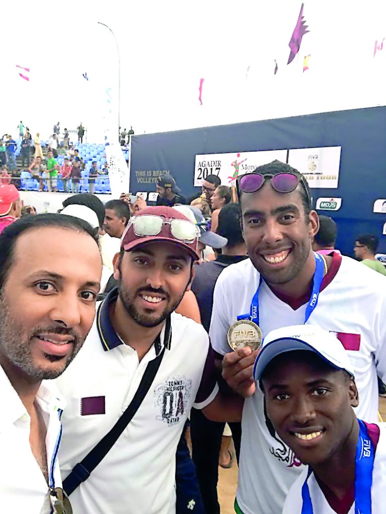 Qatari beach volleyball players Ahmed Tijan and Julio Cesar celebrate with officials after they became runners up of the FIVB Beach Volleyball World Tour Agadir Tournament in Morocco.