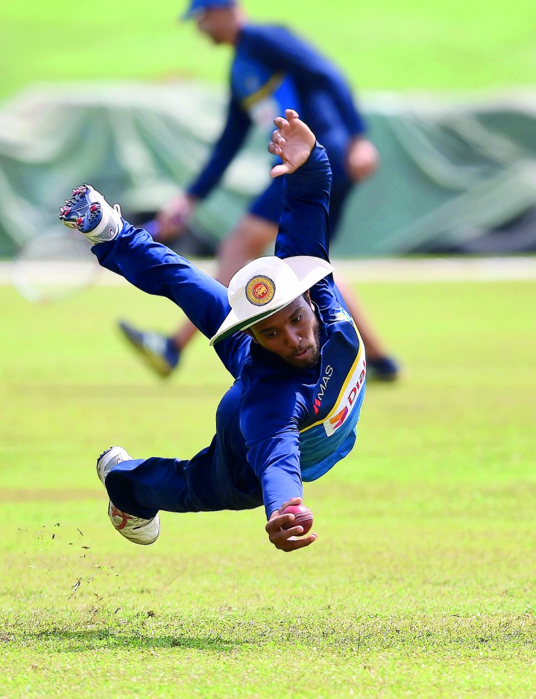 Sri Lankan cricketer Kusal Mendis catches the ball during a practice session at Galle International Cricket Stadium in Galle on Monday ahead of the first Test against India which begins today.