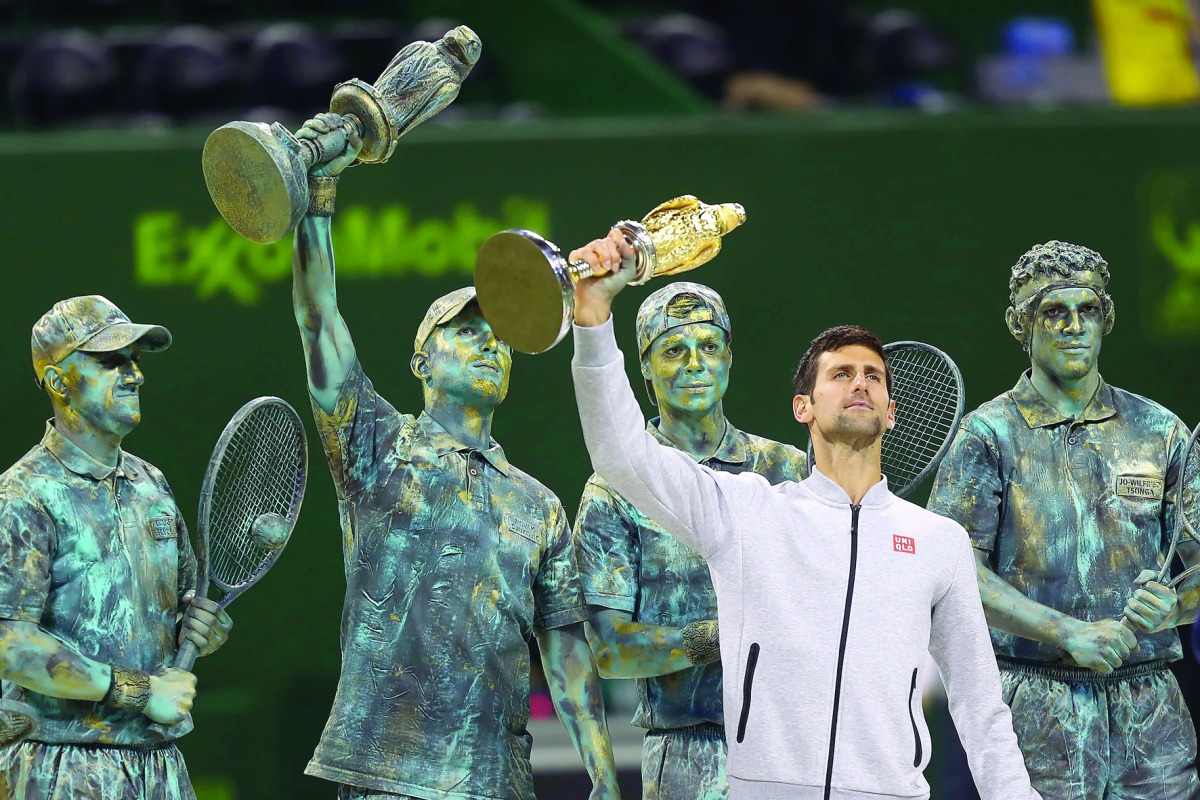 Serbia’s Novak Djokovic poses with the 2017 ExxonMobil Qatar Open trophy at the Khalifa International Tennis Complex in Doha in this file photo. Djokovic will miss the rest of the season due to an elbow injury.