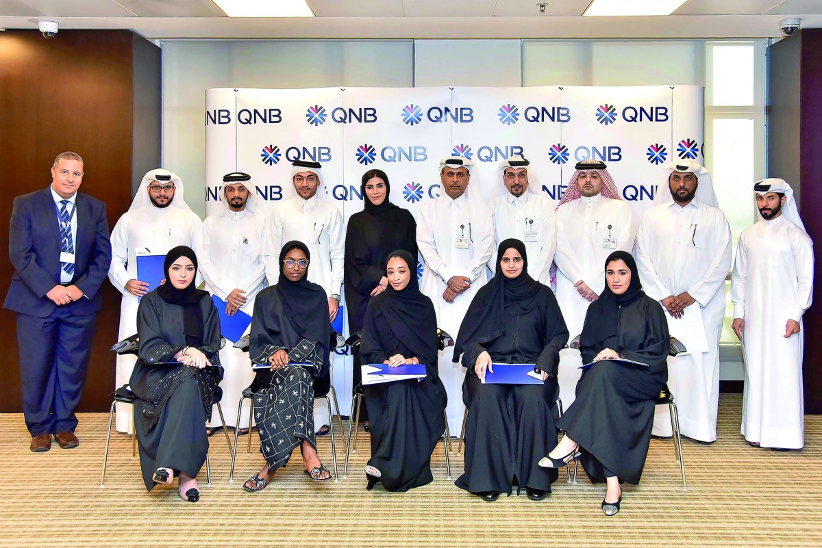 QNB officials with the induction programme participants.