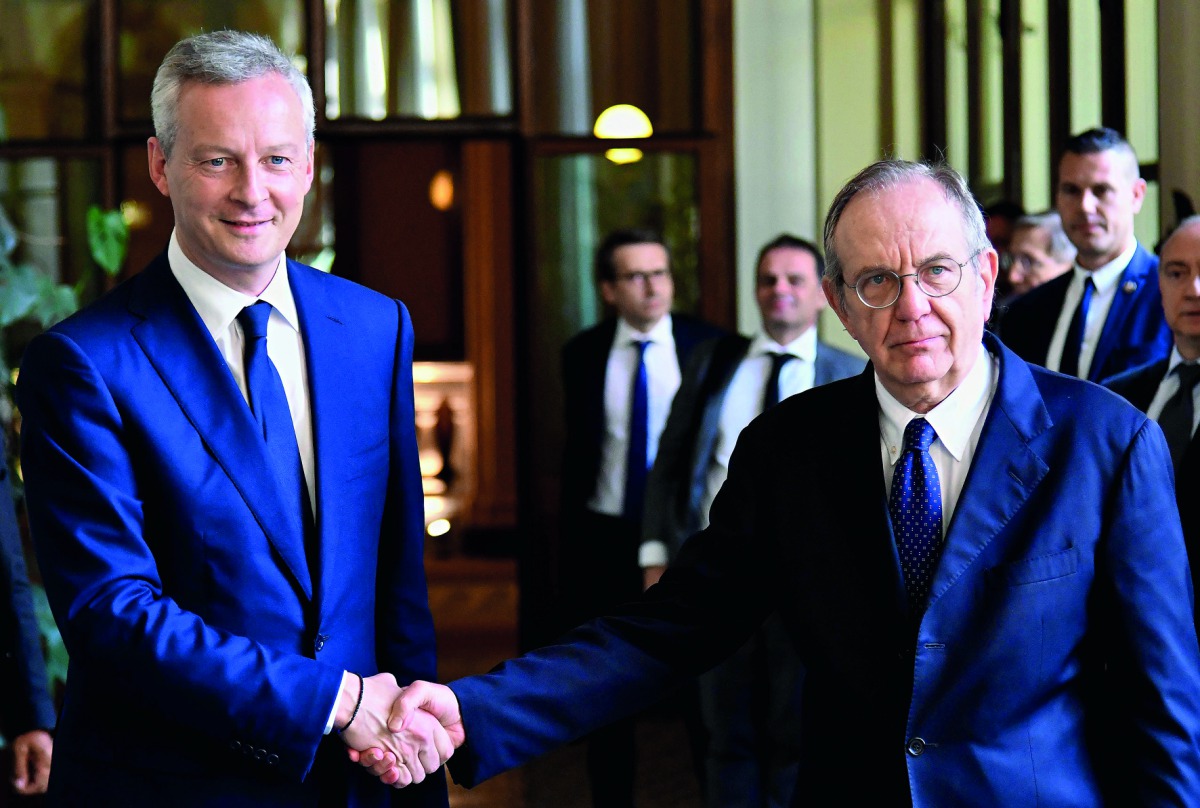 Italy’s Minister of the Economy and Finance Pier Carlo Padoan (right) shakes hands with his French counterpart Bruno Le Maire in Rome yesterday.