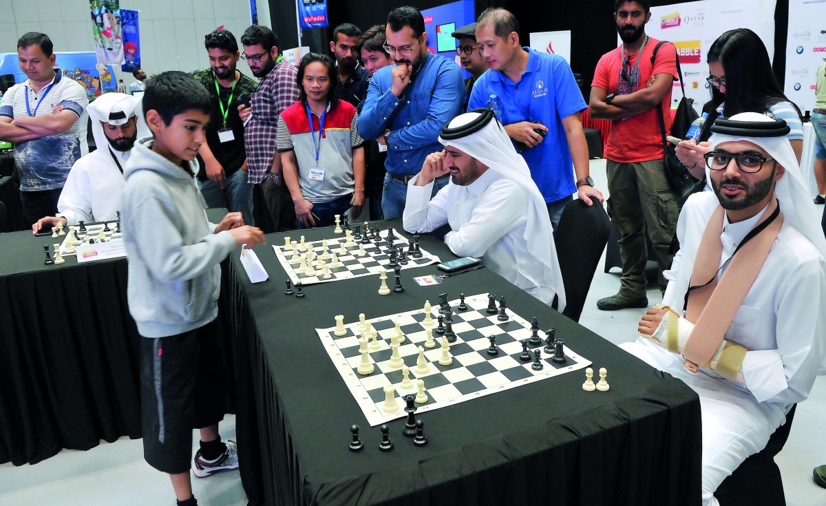 The twelve-year-old Chessmaster, Ieysaa bin Suhayl, goes against officials and guests in a speed chess game at the championships. 