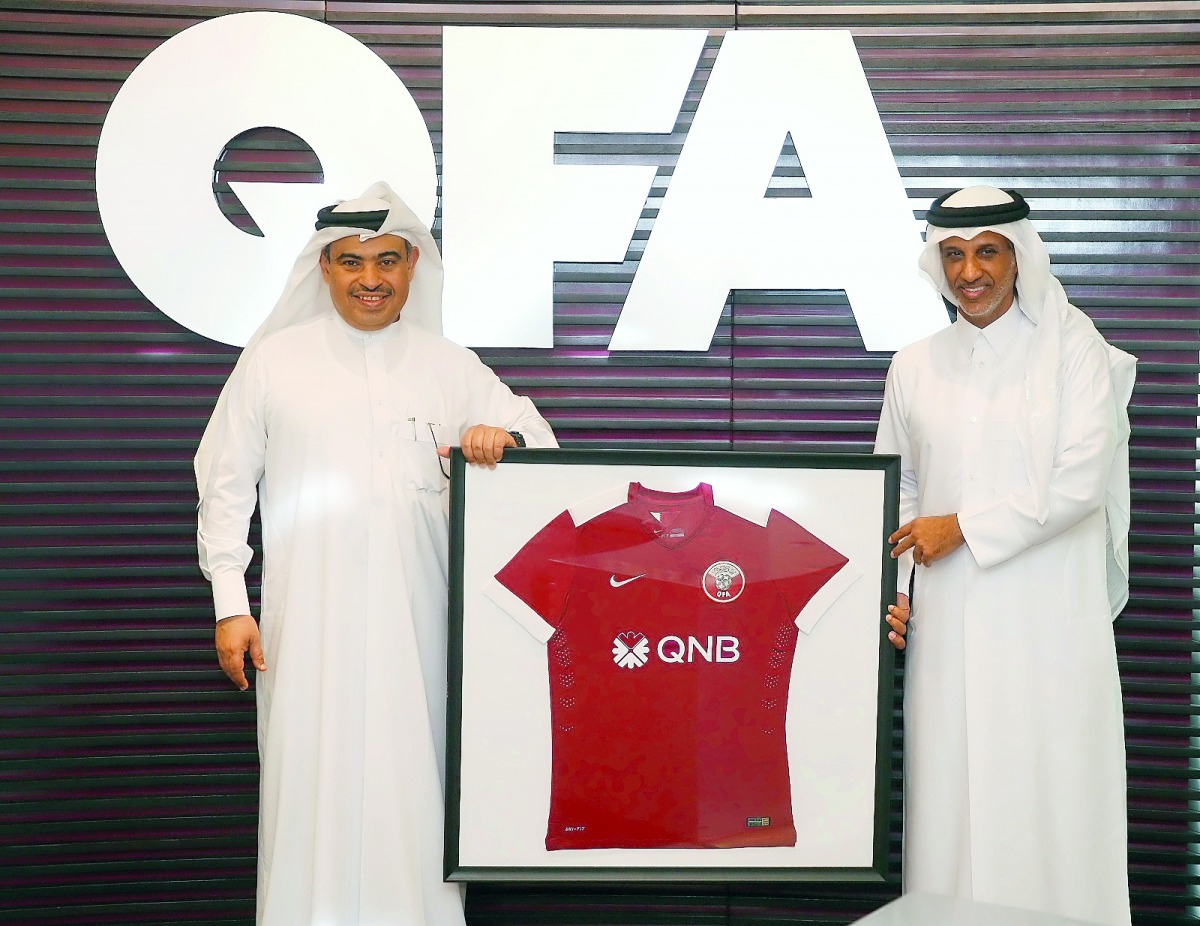 Qatar Football Association (QFA) and President of QSLM, Sheikh Hamad bin Khalifa bin Ahmed Al Thani (right) and QNB Group CEO Ali Ahmed Al Kuwari display the QNB logo on a football jersey during a press conference held yesterday.