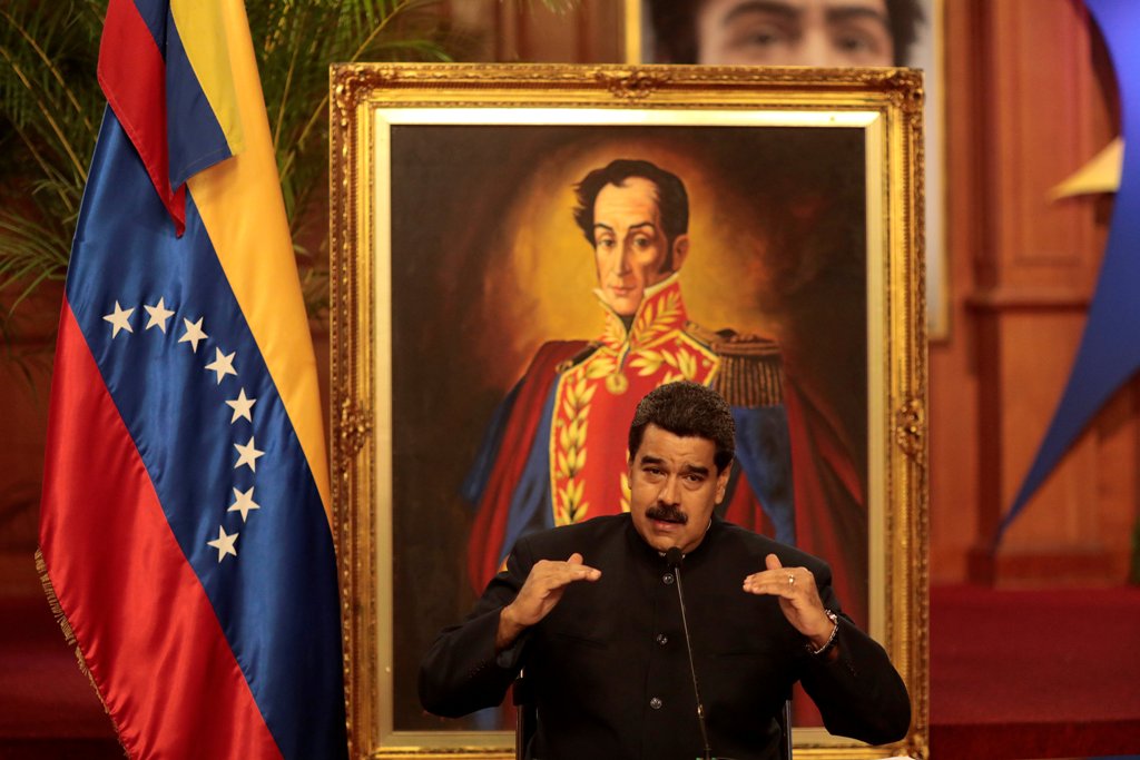 Venezuela's President Nicolas Maduro talks to the media in front of an image of Venezuela's national hero Simon Bolivar, during a news conference at Miraflores Palace in Caracas, Venezuela August 22, 2017. REUTERS/Marco Bello.