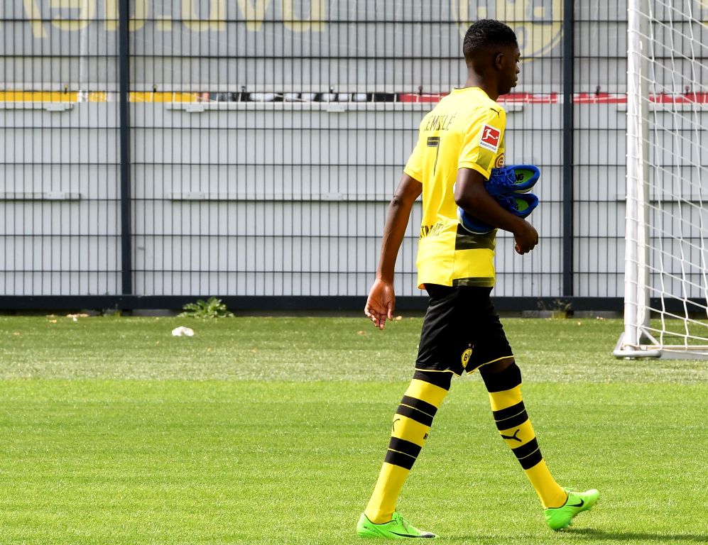 (FILES) This file photo taken on August 9, 2017 shows Dortmund's French midfielder Ousmane Dembele walking accross the pitch during a press event of German first division Bundesliga football club Borussia Dortmund in Dortmund, western Germany.  AFP / PATR
