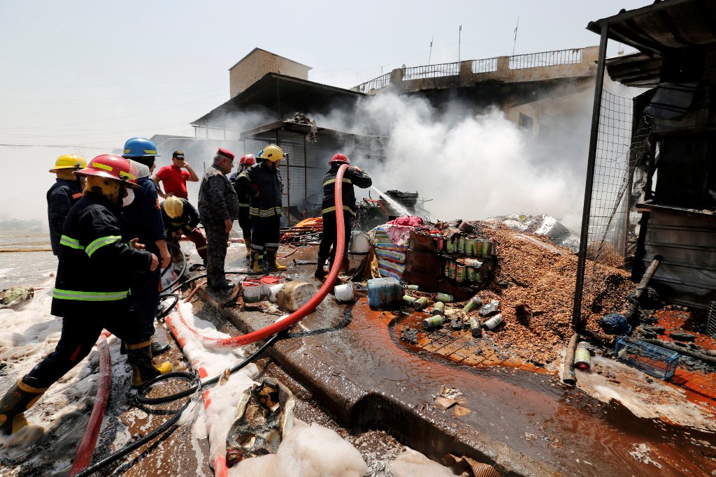 A firefighter hoses down at the site of a car bomb attack in Jamila market in Sadr City district of Baghdad, Iraq August 28, 2017. REUTERS/Wissm al-Okili
