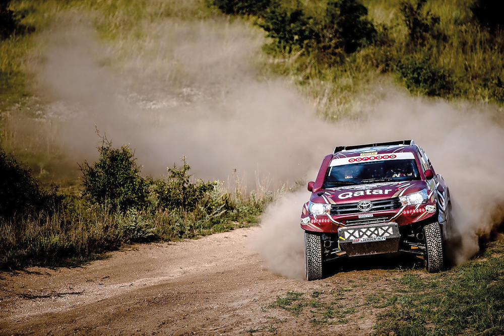 Qatari driver Nasser Saleh Al Attiyah on his way to victory during the Hungarian Baja earlier this month. INSET: Nasser Saleh Al Attiyah signing an autograph for a fan.